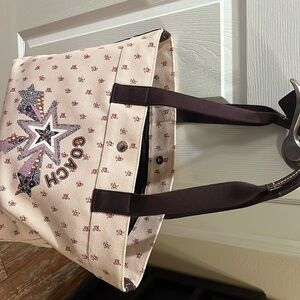 Large coach rose Tote. Color is pink with Roses on it has a snap shut.